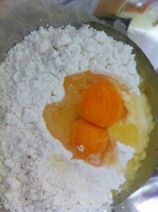 Break the eggs into a well in the flour